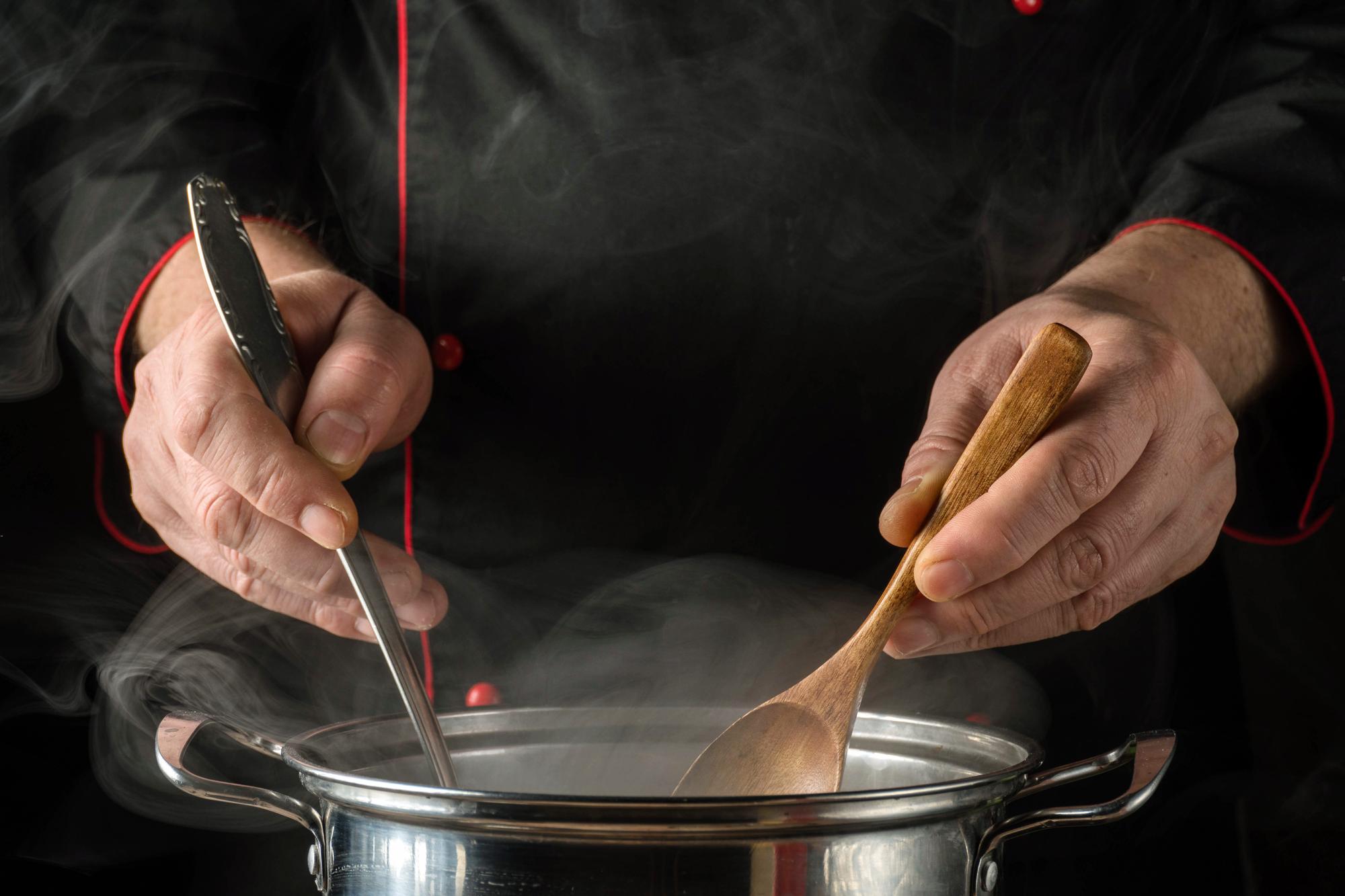 Chef hands finishing sauce